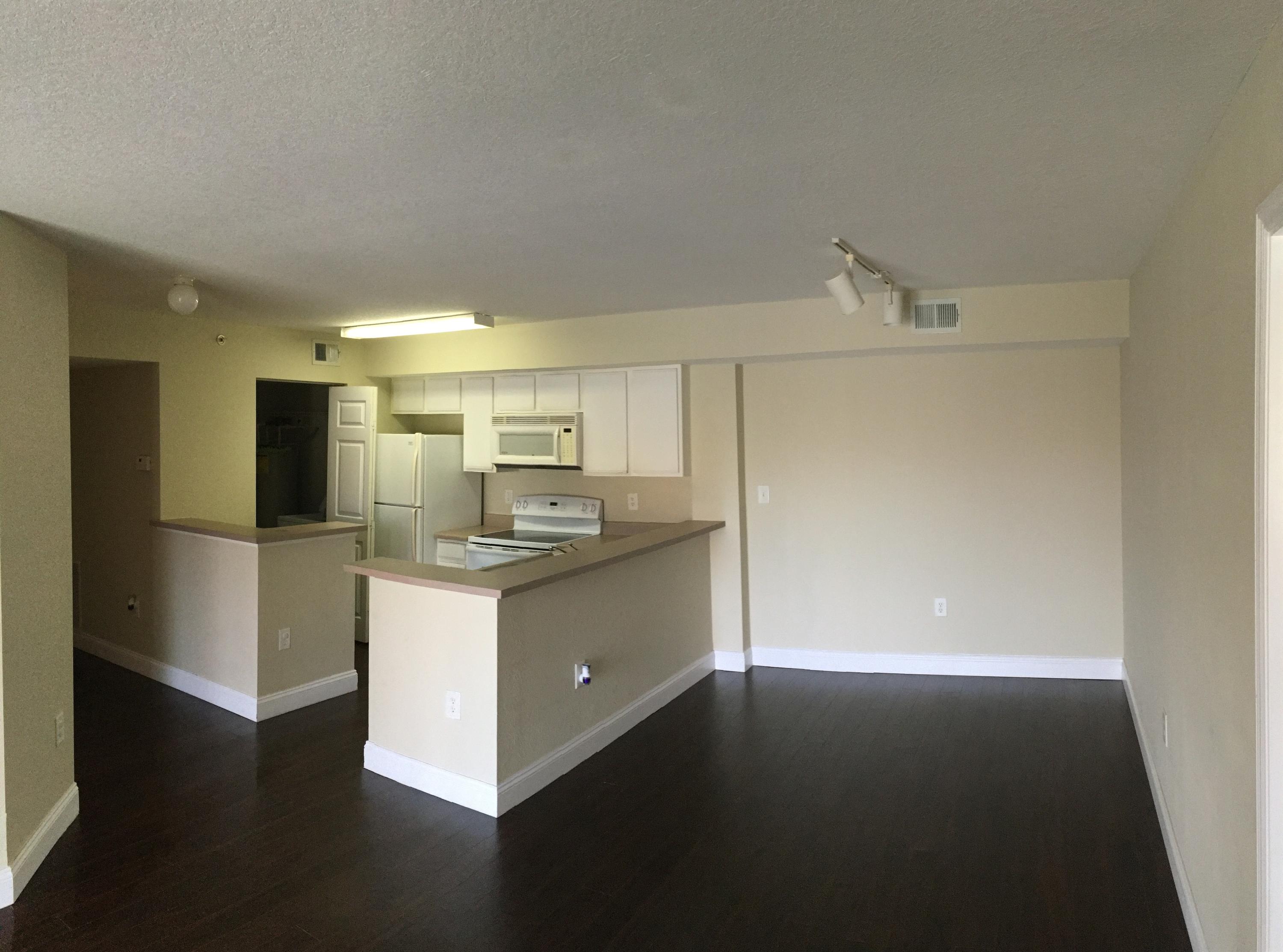 161 Southwest Palm Drive, Unit 205 Port St. Lucie, FL 34986 - Photo 7 of 22 a kitchen with stainless steel appliances a refrigerator and a stove top oven
