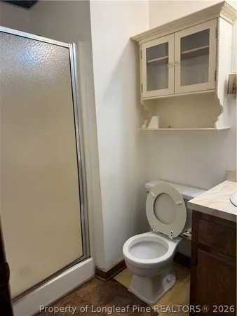 a white toilet sitting next to a bathroom sink