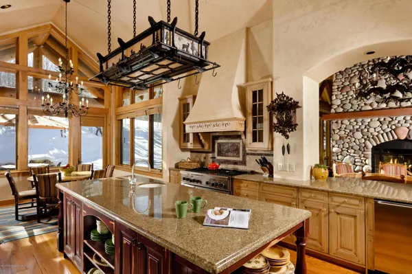 a kitchen with a table chairs stove and cabinets