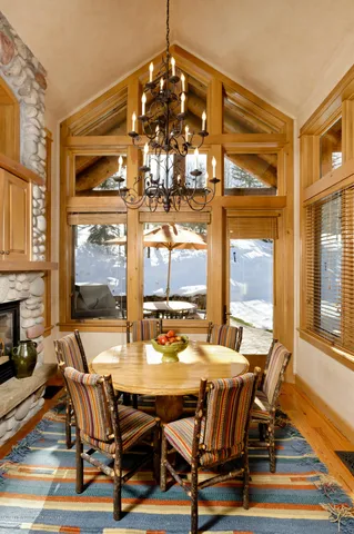 a view of a dining room with furniture wooden floor and a chandelier