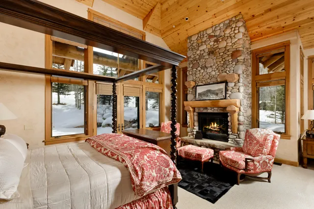 a bedroom with furniture and a fireplace