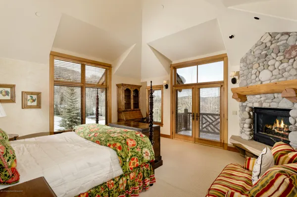 a bedroom with a bed and a fireplace