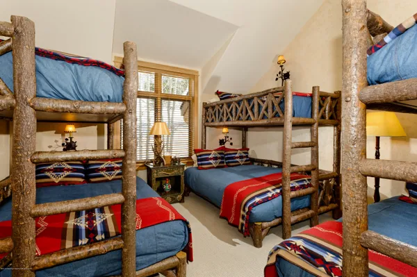 a bedroom with two beds and a window