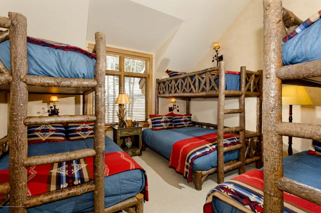 a bedroom with two beds and a window