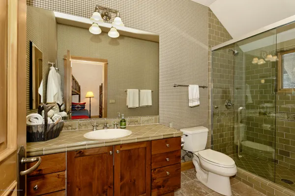 a bathroom with a double vanity sink mirror and toilet