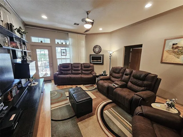 a living room with furniture fireplace and a window