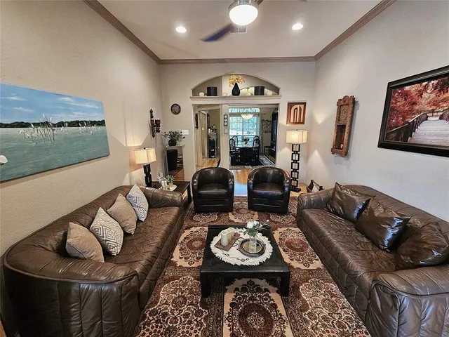 a living room with furniture a rug and a floor to ceiling window