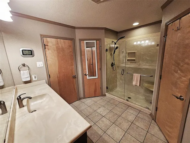 a bathroom with a shower sink and mirror