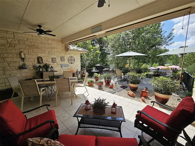 a balcony with wooden floor and trees