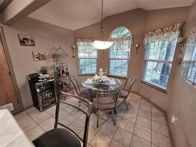 a view of a dining room with furniture and chandelier