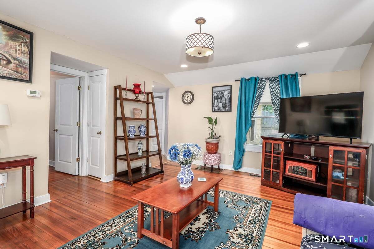 70 Dodgingtown Road Bethel, CT 06801 - Photo 5 of 27 a living room with furniture and a flat screen tv
