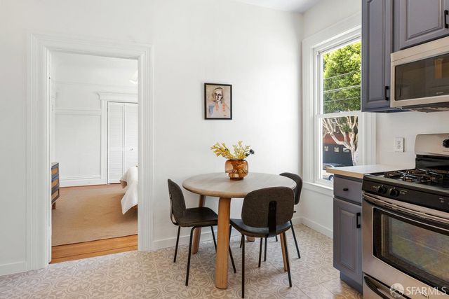 a view of a dining room with furniture and a window