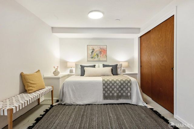 a bedroom with a bed and a couch