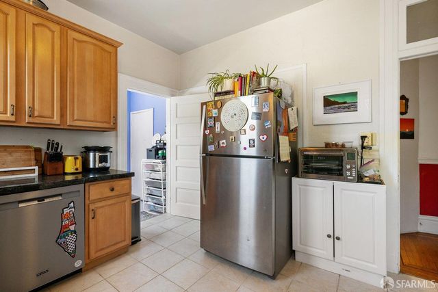 a kitchen with stainless steel appliances granite countertop a refrigerator and a stove