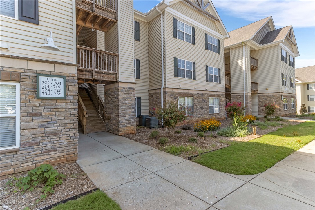 725 Lookover Drive Anderson, SC 29621 - Photo 28 of 31 Multi-level residential buildings feature stone accents, vinyl siding, and neat concrete walkways.