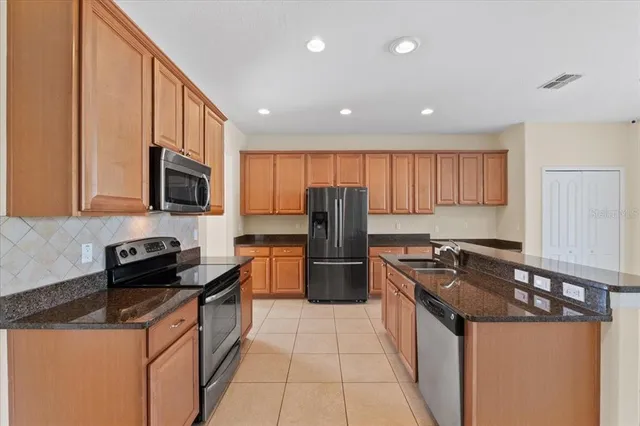 a kitchen with granite countertop a sink and cabinets