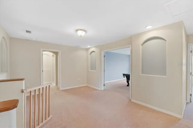 a room with a piano and a chandelier