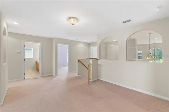 a room with pool table and wooden floor