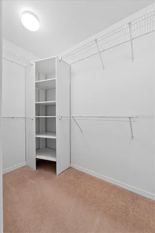 an empty room with a ceiling fan and a window