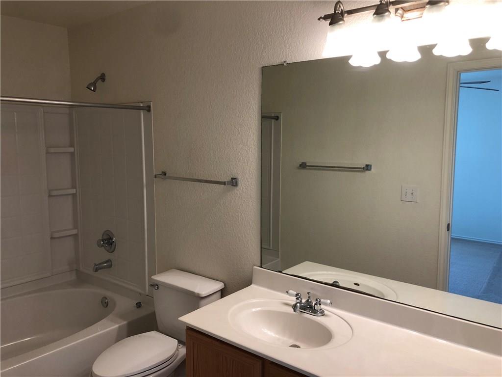 6912 Walkup Lane Austin, TX 78747 - Photo 9 of 14 a bathroom with a sink toilet and shower
