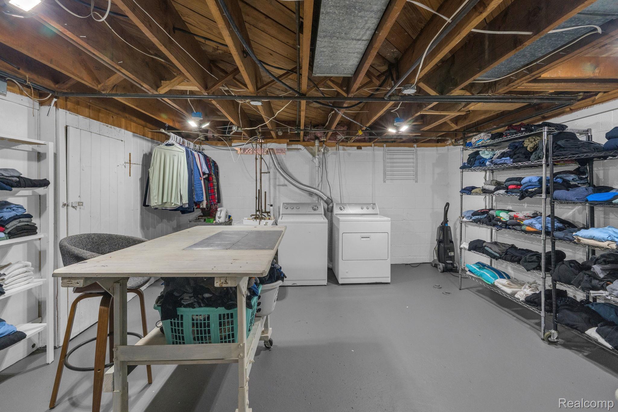 21 Devonshire Road Pleasant Ridge, MI 48069 - Photo 34 of 35 Utility area featuring an exposed beam ceiling, painted concrete flooring, and white painted walls