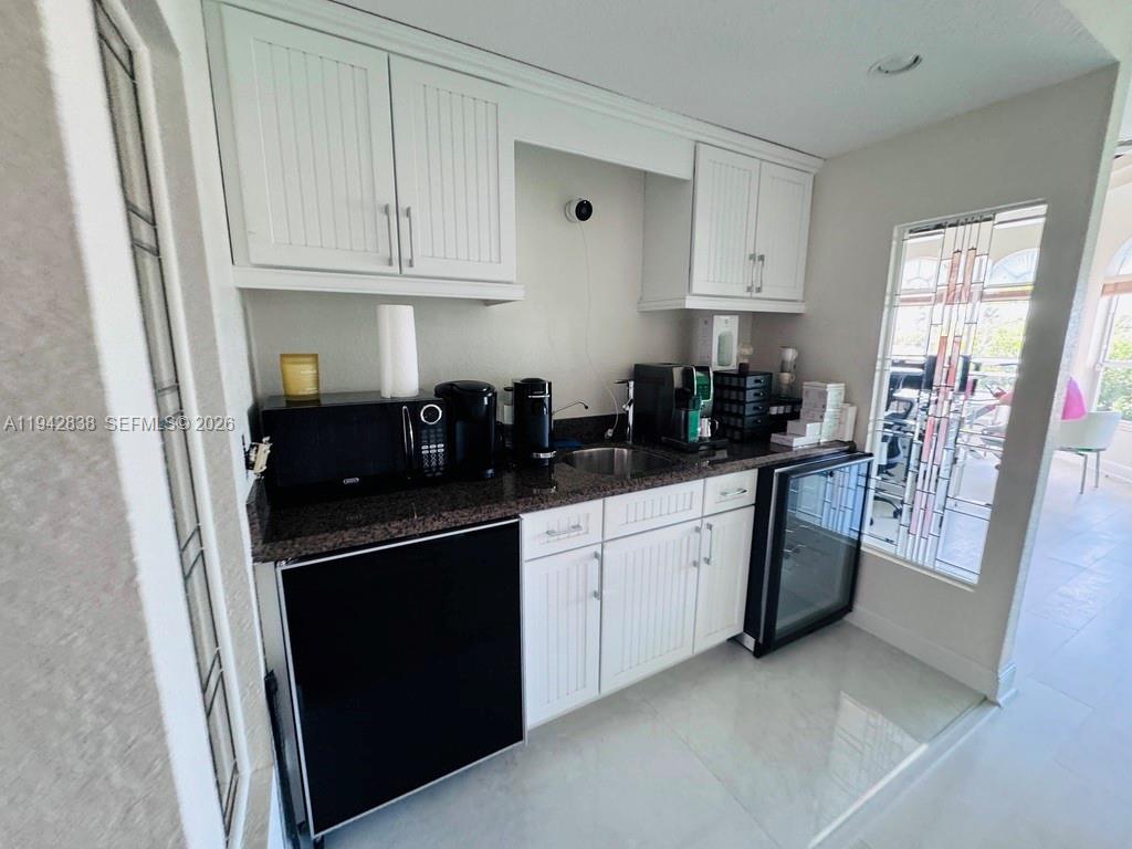 4130 Northeast 23rd Avenue Lighthouse Point, FL 33064 - Photo 11 of 20 a kitchen with stainless steel appliances granite countertop a refrigerator and a sink