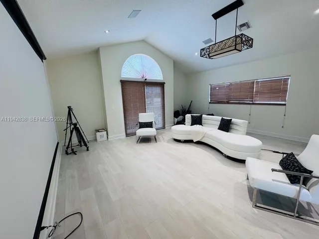 a bedroom with furniture and a ceiling fan