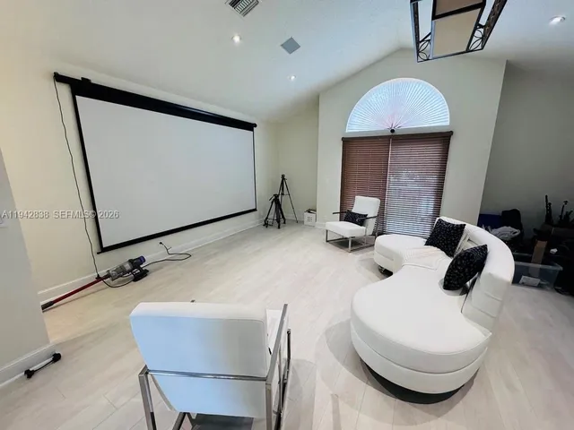 a room with furniture mirror and wooden floor