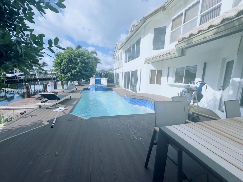 4130 Northeast 23rd Avenue Lighthouse Point, FL 33064 - Photo 16 of 20 a view of a patio with couches table and chairs and potted plants