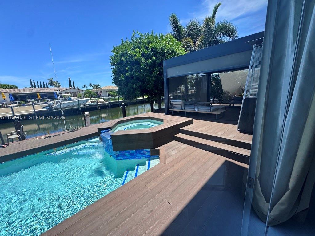 4130 Northeast 23rd Avenue Lighthouse Point, FL 33064 - Photo 17 of 20 a swimming pool with outdoor seating