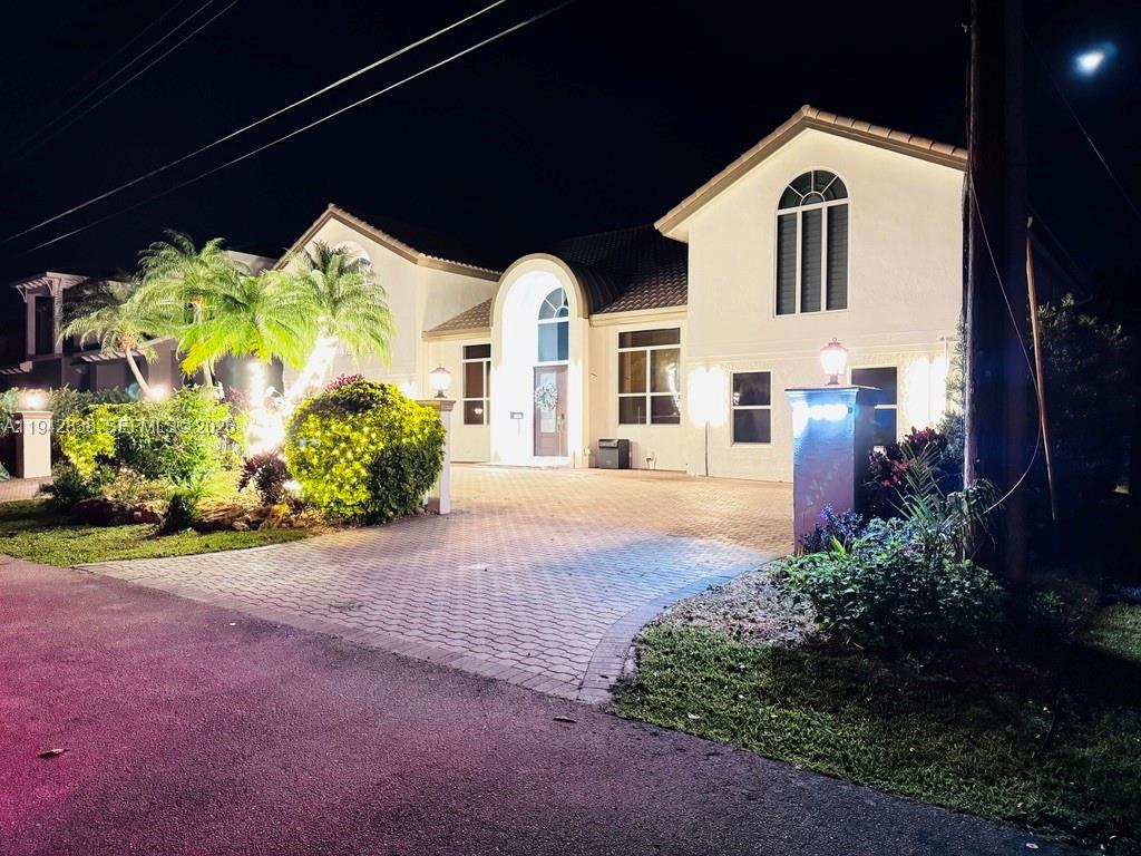 4130 Northeast 23rd Avenue Lighthouse Point, FL 33064 - Photo 20 of 20 a front view of a house with a yard