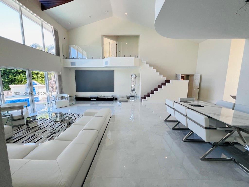 4130 Northeast 23rd Avenue Lighthouse Point, FL 33064 - Photo 2 of 20 a living room with furniture and a flat screen tv