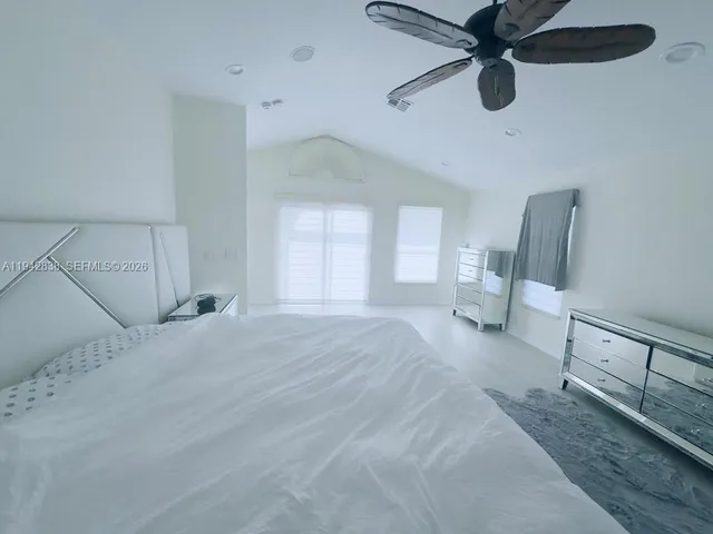 a view of empty room with a ceiling fan and window