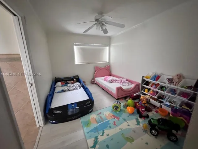 a bedroom with bed and a window