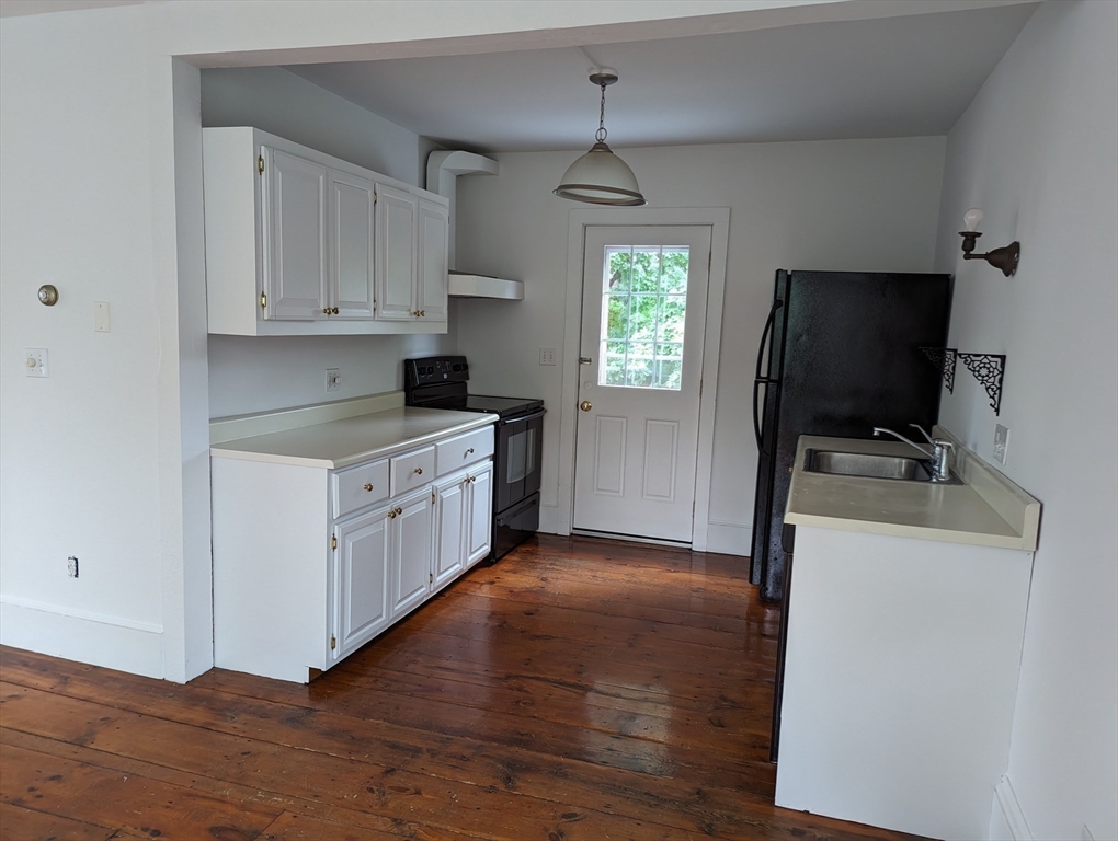 33 Merrill Street, Unit 3 Newburyport, MA 01950 - Photo 12 of 17 a kitchen with sink a microwave and cabinets