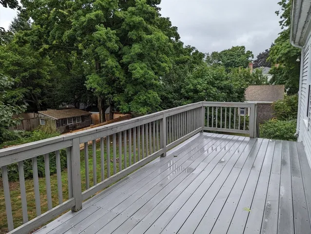 a view of balcony with wooden floor and fence