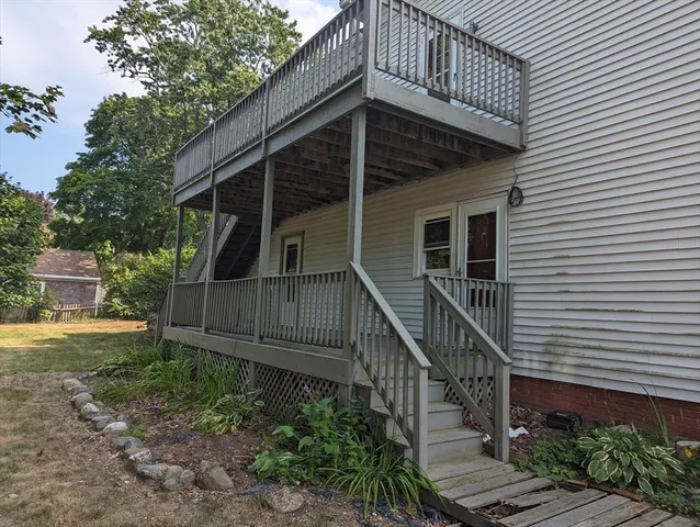 a view of a house with wooden deck