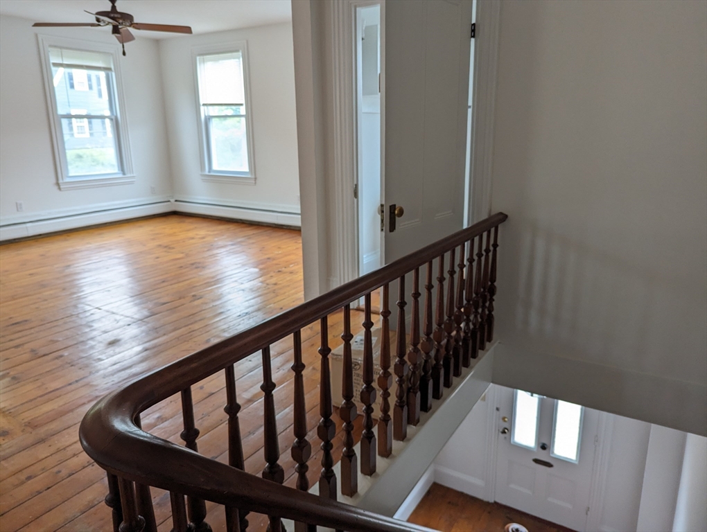 33 Merrill Street, Unit 3 Newburyport, MA 01950 - Photo 4 of 17 a view of staircase with wooden floor and a window
