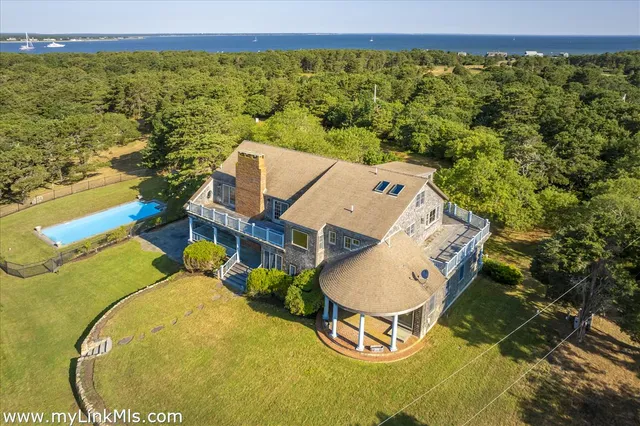 an aerial view of a house with a swimming pool
