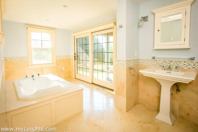 a view of an empty room with window and fire place