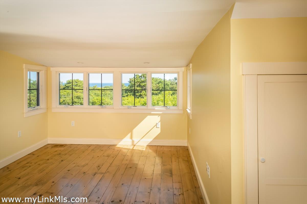 56 North Neck Road Edgartown, MA 02539 - Photo 19 of 63 a view of an empty room with wooden floor and a window