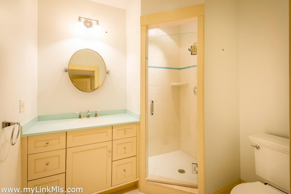 56 North Neck Road Edgartown, MA 02539 - Photo 29 of 63 a bathroom with a granite countertop sink mirror and a shower
