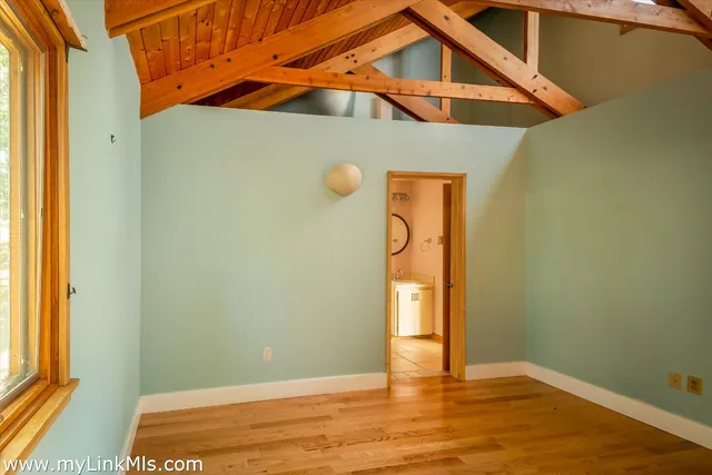 a view of a house with a yard and potted plants
