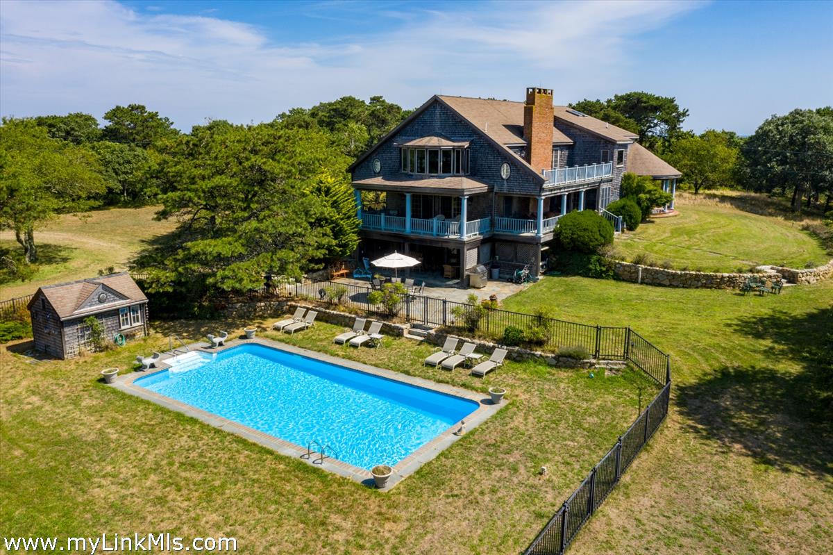 56 North Neck Road Edgartown, MA 02539 - Photo 60 of 63 a view of a house with swimming pool and chairs