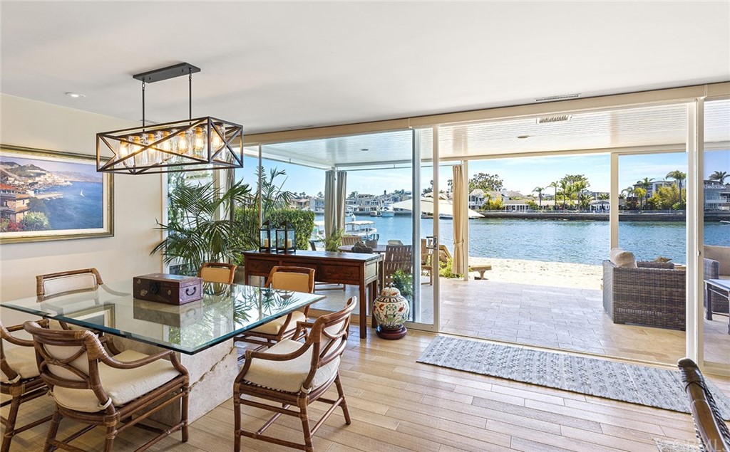 7 Beacon Bay Newport Beach, CA 92660 - Photo 11 of 59 a dining room with furniture a chandelier and wooden floor