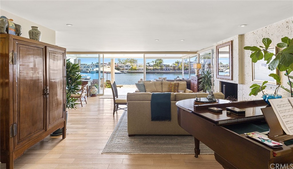 7 Beacon Bay Newport Beach, CA 92660 - Photo 12 of 59 a living room with furniture and a floor to ceiling window