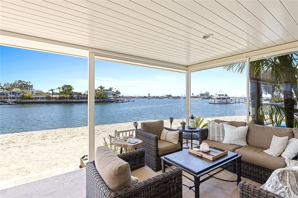 7 Beacon Bay Newport Beach, CA 92660 - Photo 14 of 59 a balcony with furniture and a floor to ceiling window