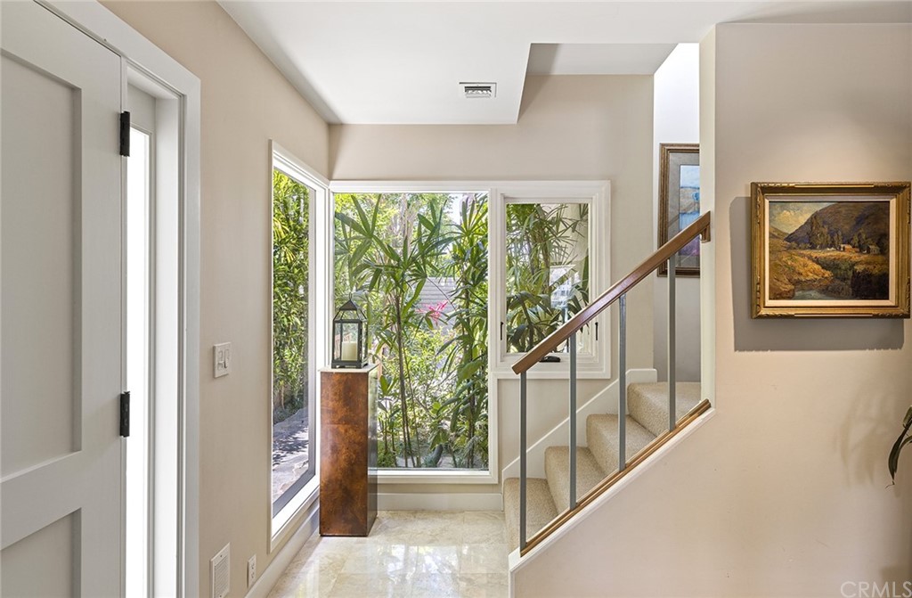 7 Beacon Bay Newport Beach, CA 92660 - Photo 17 of 59 a view of an entryway with a floor to ceiling window