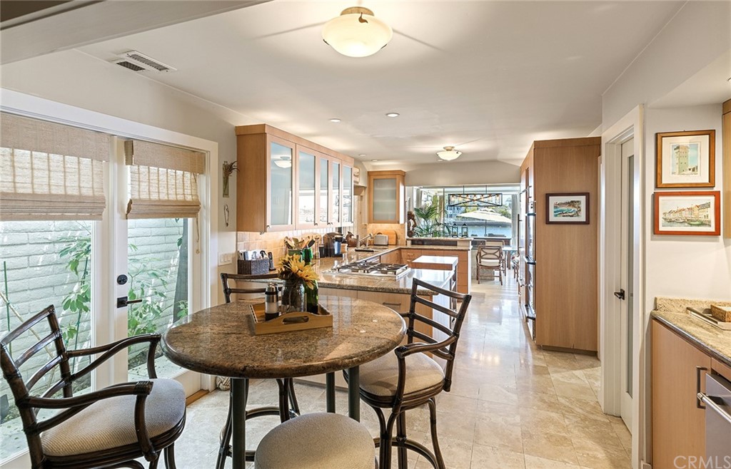 7 Beacon Bay Newport Beach, CA 92660 - Photo 19 of 59 a view of a dining room with furniture and wooden floor