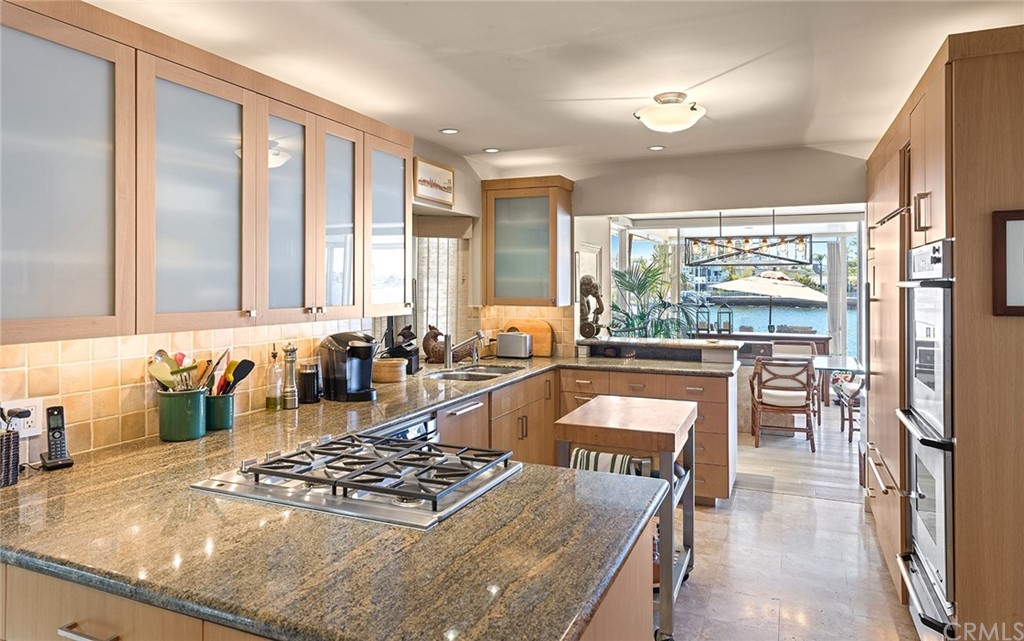 7 Beacon Bay Newport Beach, CA 92660 - Photo 22 of 59 a large kitchen with a large window and stainless steel appliances